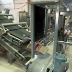 bag kicker and bag flattener conveyor