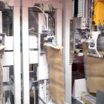 placing paper valve bags on filling spout