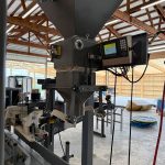 Close Up of Model 350 DigitalPLUS Open Mouth Bagging Machine Attached to Hopper