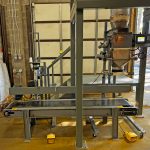 repackaging water filter media from bulk bags into open mouth bags