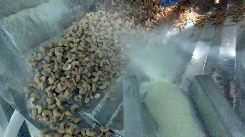 Applying seasoning using a feeder into a rotating drum