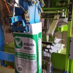 open mouth bag placed on spout by automatic bag placer