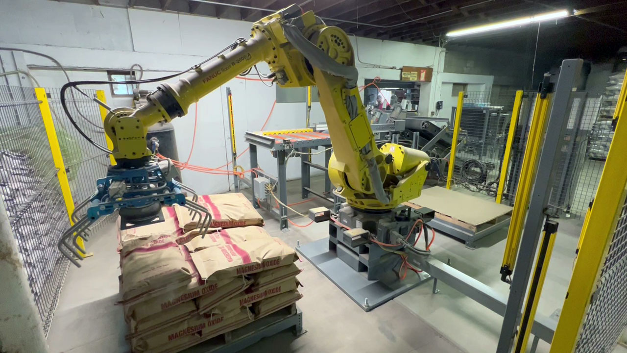 robotic palletizer stacking bags on pallet fanuc R2000iA robot