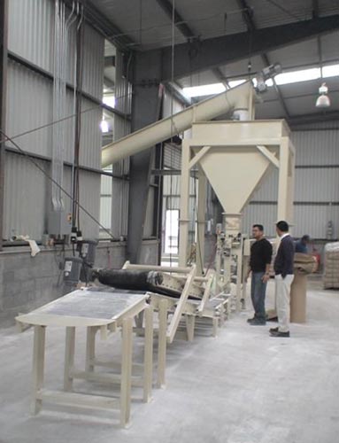 valve bag filling system with conveyor and bag flattener