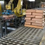 Additional view of Fanuc robot picking up 100 lb. bag of minerals using bag gripper tool and stacking on an almost full pallet