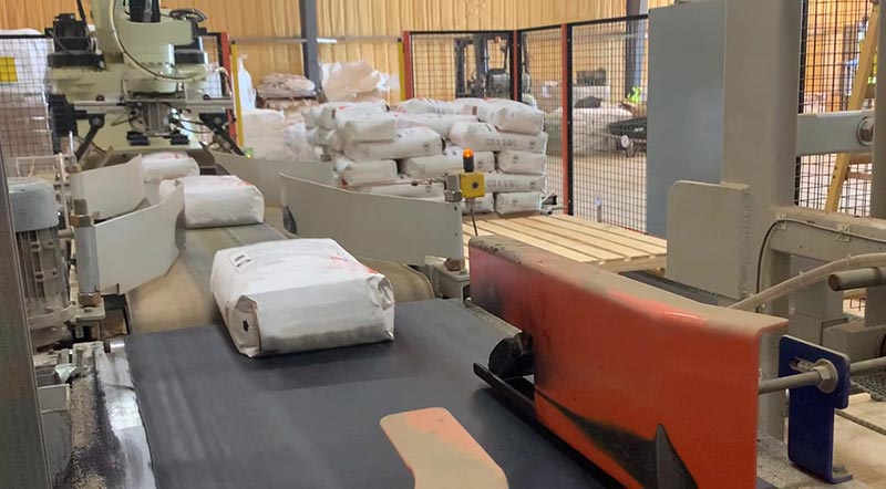 filled bags of aggregate on bag conveyor