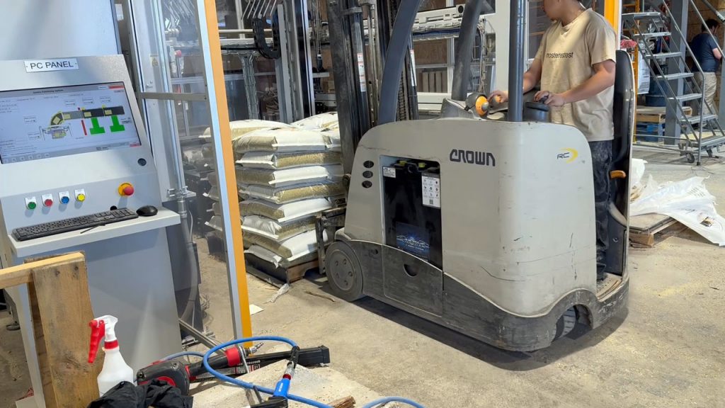 fork truck lift removing full pallet of animal feed bags from sentrystack palletizer