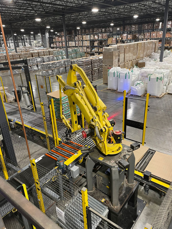 Palletizing robot used in a dry pet food bagging system