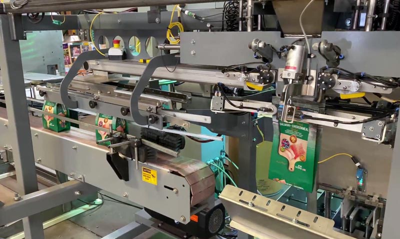 filling stand up zipper pouches with dry pet food and treats